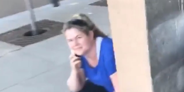 A video grab shows Alison Ettel ducking behind a wall while being recorded allegedly calling the police on an 8-year-old girl.