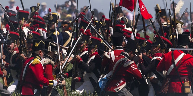 Performers take part in the re-enactment of the battle of Ligny, during the bicentennial celebrations for the Battle of Waterloo, in Ligny, Belgium, June 14, 2015.