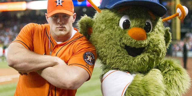HOUSTON, TX - MARCH 31: Defensive end J.J. Watt of the Houston Texans poses with Houston Astros mascot Orbit after throwing out the first pitch during opening night at Minute Maid Park as the Texas Rangers played the Houston Astros on March 31, 2013 in Houston, Texas. (Photo by Bob Levey/Getty Images)