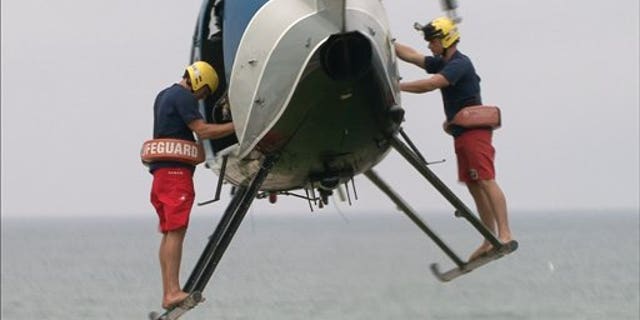 In this undated image released by The Weather Channel, two lifeguards prepare to make a rescue in a scene from ""Lifeguard!," about beach rescuers in southern California.
