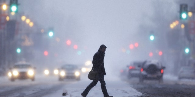 Jan. 21, 2014: A man crosses Broad Street during a winter snowstorm in Philadelphia.
