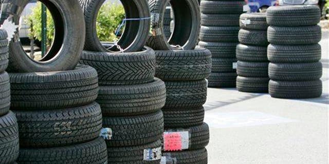 Tires are displayed outside of a Goodyear Tires shop in San Jose.