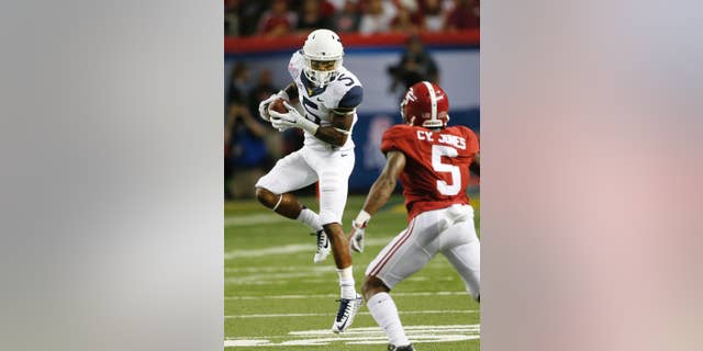 West Virginia wide receiver Mario Alford (5) makes a catch as Alabama defensive back Cyrus Jones (5) defends during the first half of an NCAA college football game Saturday, Aug. 30, 2014, in Atlanta. (AP Photo/John Bazemore)