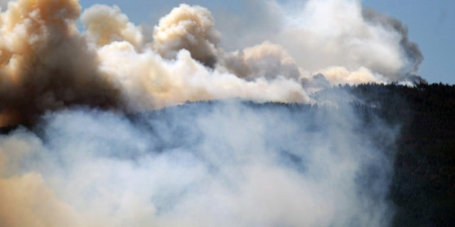 June 12, 2012: Smoke billows from a wildfire burning west of Fort Collins, Colo.