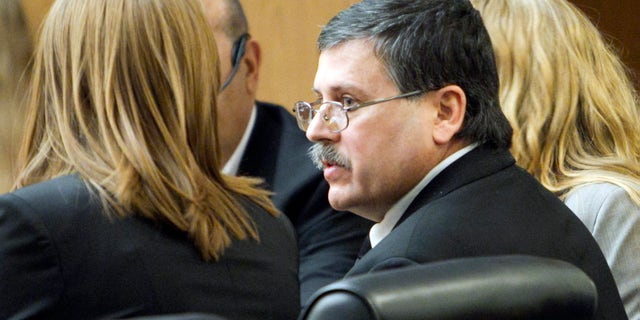 Feb. 22: Faleh Hassan Almaleki sits with an attorney during his trial in Phoenix. A jury convicted Almaleki, a 50-year-old Iraqi immigrant, of second-degree murder for running over and killing his daughter in a case prosecutors called an "honor killing."