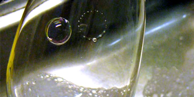 Daughter bubbles can be observed while washing dishes. Here two bubbles are blown on a wine glass using a small straw and standard soapy water; a ring of smaller bubbles forms after the bubble on the right pops.