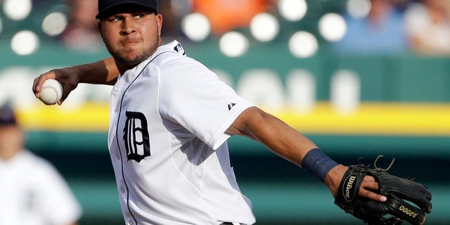FILE - In this July 10, 2013, file photo, Detroit Tigers shortstop Jhonny Peralta makes a throw to first during a baseball game against the Chicago White Sox in Detroit. A person familiar with the negotiations tells The Associated Press that free agent shortstop Peralta and the St. Louis Cardinals have agreed on a four-year contract. (AP Photo/Carlos Osorio, File)