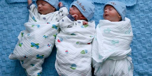 Identical triplets Alexander, Nicholas and Timothy Whiteley, left to right, sleep at their home in St. Clair Shores, Mich., Wednesday, Feb. 25, 2015. (AP Photo/Paul Sancya)
