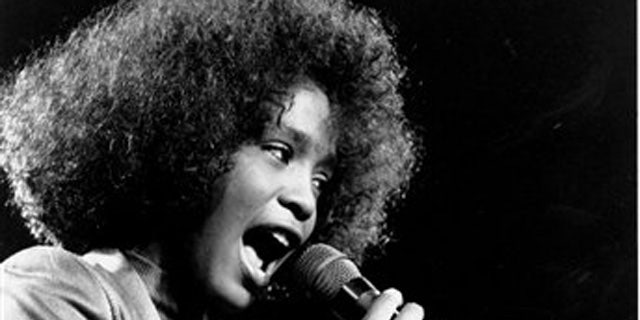 In this May 10, 1986, file photo, American singer Whitney Houston belts out a song during her segment of a benefit concert at Boston Garden. Houston died Saturday, Feb. 11, 2012, she was 48. (AP Photo/Elise Amendola)