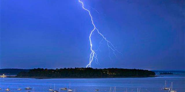 In this Sept. 11, 2013, file photo, lightning strikes north of Mackworth Island in Maine.