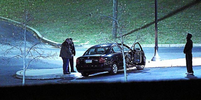 January 20, 2014: Police investigate a car, left, at the athletic center of Widener University in Chester, Pa. after a student was shot. Authorities warned students to remain indoors until further notice. (AP Photo/Delaware County Daily Times, Robert J. Gurecki)