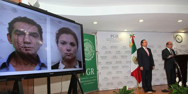 CORRECTS DAY OF THE WEEK - Mexico's Attorney General, Jesus Murillo Karam, right, flanked by Tomas Zeron director of Mexico's Criminal Investigation Agency, speaks during a news conference in Mexico City, Sunday Dec. 7, 2014. While showing a photo of the mayor of Iguala, Jose Luis Abarca and his wife, Maria de los Angeles Pineda Villa, Attorney General Murillo Karam confirmed Sunday that one of the college students missing since September, has been identified among charred remains found several weeks ago near a garbage dump. He said the student is Alexander Mora, based on material extracted from the bone fragment and analyzed by forensics experts at a laboratory in Innsbruck, Austria. The mayor and his wife are among the 80 people arrested so far for the disappearance of the students. (AP Photo/Marco Ugarte)