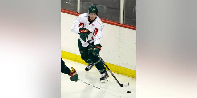 Minnesota Wild defenseman Ryan Suter passes the puck during NHL hockey training camp in St. Paul, Minn., Friday, Sept. 19, 2014. (AP Photo/Ann Heisenfelt)