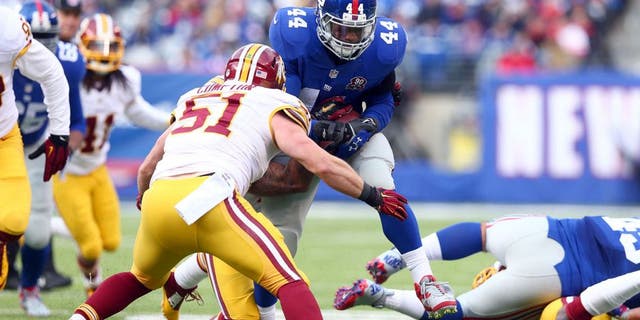 Dec 14, 2014; East Rutherford, NJ, USA; New York Giants running back Andre Williams (44) carries against Washington Redskins inside linebacker Will Compton (51) during the first quarter of a game at MetLife Stadium. Mandatory Credit: Brad Penner-USA TODAY Sports
