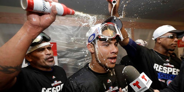 Chicago Cubs catcher Willson Contreras, center, has beer poured on him in the locker room after Game 4 of baseball's National League Division Series against the San Francisco Giants in San Francisco, Tuesday, Oct. 11, 2016. The Cubs won 6-5. (AP Photo/Marcio Jose Sanchez)
