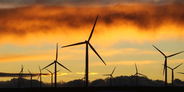 Jan. 19: Clouds turn orange and purple as the sun sets behind the Happy Jack Wind Farm east of Cheyenne, Wyo. Wyoming wind energy developers are holding promotional events in Cheyenne and Casper this week to highlight the positives of the new industry as it works to carve out a place for itself in the state. (AP)