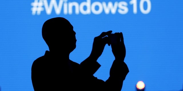File photo - A Microsoft delegate takes a picture during the launch of the Windows 10 operating system in Kenya's capital Nairobi, July 29, 2015.