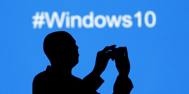 File photo - A Microsoft delegate takes a picture during the launch of the Windows 10 operating system in Kenya's capital Nairobi, July 29, 2015.