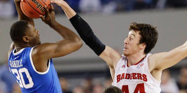 FILE - In this April 5, 2014, file photo, Wisconsin forward Frank Kaminsky (44) blocks a shot by Kentucky forward Julius Randle (30) during the second half of the NCAA Final Four tournament college basketball semifinal game in Arlington, Texas. The one-point loss to Kentucky in the Final Four still stings for Kaminsky. But instead of stewing all offseason about his team being one possession short of playing for a national title, Kaminsky says it's all about motivation. (AP Photo/Eric Gay, File)
