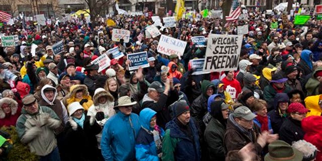 April 16: Supporters cheer as they listen to former Alaska Gov. Sarah Palin speak at a tax day tea party rally in Madison, Wis. (AP)