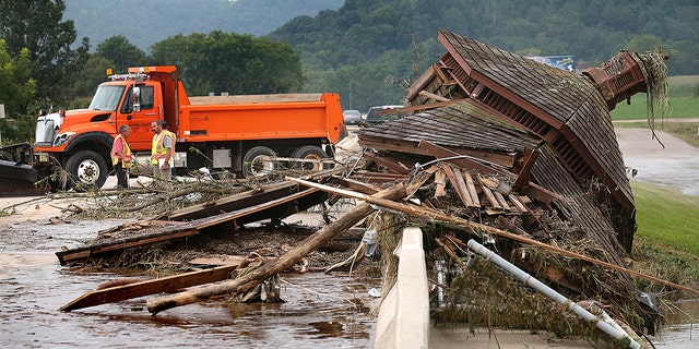 A gazebo from nearby Veterans Memorial Park is seen pinned up against the Hwy. 14/61 bridge Tuesday, Aug. 28, 2018, in Coon Valley, Wis., moved there by flood water from Coon Creek. Rain continued to fall through early Tuesday in eastern Wisconsin with another heavy round expected Tuesday night into Wednesday. (Peter Thomson/La Crosse Tribune via AP)