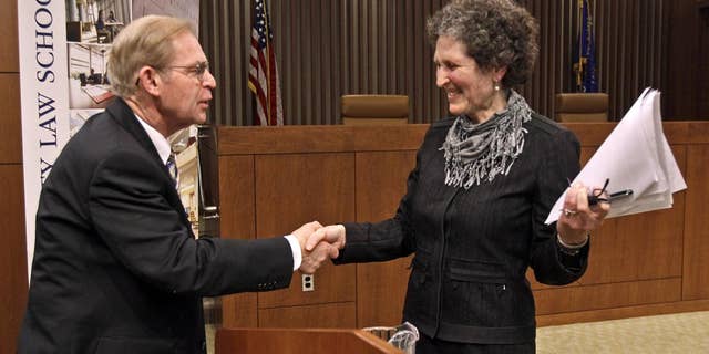 Justice David Prosser shakes hands with Assistant Attorney General JoAnne Kloppenburg after their debate for the Wisconsin Supreme Court at the Marquette University Law School in Milwaukee. (AP Photo/Milwaukee Journal-Sentinel, Benny Sieu)