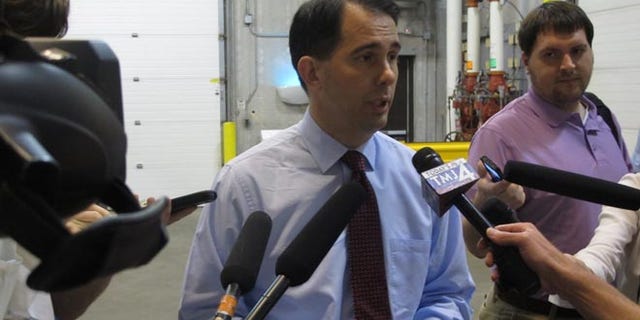 Gov. Scott Walker speaks to reporters in Madison, Wis. on Thursday, June 26, 2014.