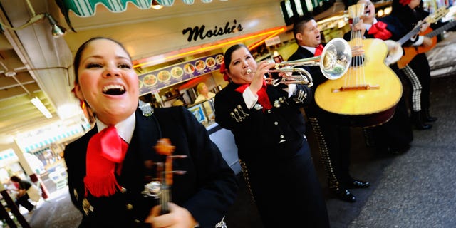 LOS ANGELES, CA - MAY 05: Judith Merillo (L) Esmeralda Garcia (2nd-L) Guillermo Nunez (C) Mariana Nanez and Ileana Garcia (R) members of the all-female strolling Mariachi band, Ellas Son, perform at Los Angeles Farmer Market during Cinco de Mayo festivities on May 5, 2011 in Los Angeles, California. Nunez was filling for the recovering injured female base player who was shot in the arm at a Mexican restaurant two weeks ago. Cinco de Mayo celebrates the 1862 Mexican victory over the French in the Battle of Puebla. (Photo by Kevork Djansezian/Getty Images)