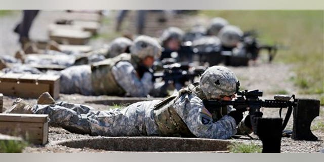 FILE - This Sept. 18, 2012 file photo shows female soldiers training on a firing range while wearing new body armor in Fort Campbell, Ky. Only a small fraction of Army women say theyd like to move into one of the newly opening combat jobs, but those few who do, say they want a job that takes them right into the heart of battle, according to preliminary results from a survey of the services nearly 170,000 women. (AP Photo/Mark Humphrey, File)