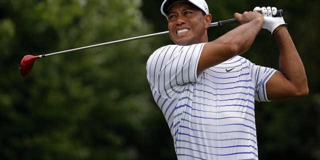 FILE - In this Friday, Aug. 8, 2014 file photo, Tiger Woods winces after tee shot on the sixth hole during the second round of the PGA Championship golf tournament at Valhalla Golf Club in Louisville, Ky. Tiger Woods removed himself from consideration for the Ryder Cup team Wednesday evening, Aug. 13, 2014 with a clear message that he is not healthy enough to play. (AP Photo/Jeff Roberson, File)