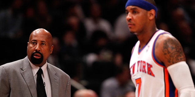 NEW YORK, NY - MAY 03: (L-R) Head coach Mike Woodson and Carmelo Anthony #7 of the New York Knicks look on against the Miami Heat in Game Three of the Eastern Conference Quarterfinals in the 2012 NBA Playoffs on May 3, 2012 at Madison Square Garden in New York City. NOTE TO USER: User expressly acknowledges and agrees that, by downloading and or using this photograph, User is consenting to the terms and conditions of the Getty Images License Agreement. (Photo by Jeff Zelevansky/Getty Images) *** Local Caption *** Mike Woodson; Carmelo Anthony