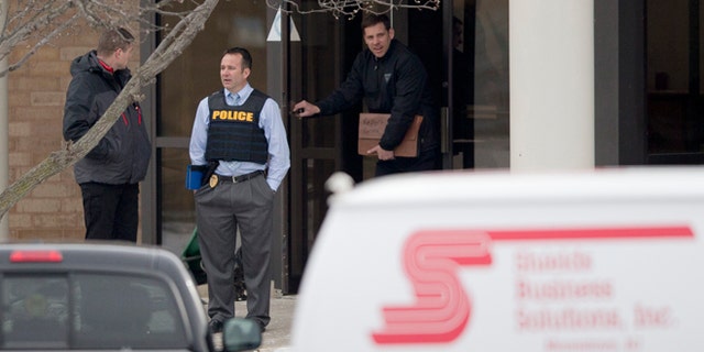 Feb. 23, 2015: Investigators stand at the scene of a shooting at a Shields Business Solutions office in Moorestown, N.J. (AP)