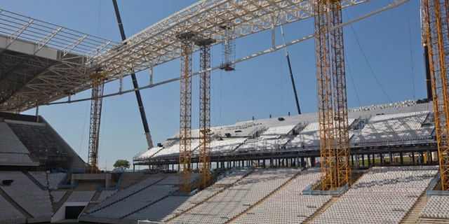 FILE - In this March 15, 2014 file photo, Brazilian club Corinthians soccer players practice at the Itaquerao stadium in Sao Paulo, Brazil. Brazilian organizers are adding safety features where a worker died in the stadium hosting the World Cup opener, hoping to quickly reverse an order that halted construction in part of the venue. The addition of new safety rails comes a day after labor officials said the installation of 20,000 temporary seats at the Itaquerao stadium could not continue until safety concerns were addressed. On Saturday March 29th, 2014, a 23-year-old worker died after falling from about 26 feet while installing the seats needed for the opener. (AP Photo / Andre Penner, File)