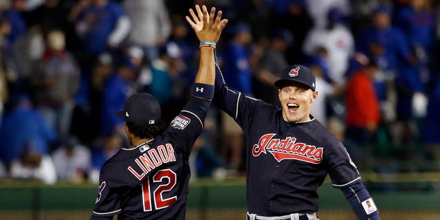 Cleveland Indians' Brandon Guyer, right, celebrates with Francisco Lindor (12) after Game 4 of the Major League Baseball World Series against the Chicago Cubs, Saturday, Oct. 29, 2016, in Chicago. The Indians won 7-2 to take a 3-1 lead in the series. (AP Photo/Nam Y. Huh)