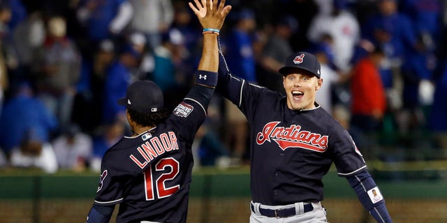 Cleveland Indians' Brandon Guyer, right, celebrates with Francisco Lindor (12) after Game 4 of the Major League Baseball World Series against the Chicago Cubs, Saturday, Oct. 29, 2016, in Chicago. The Indians won 7-2 to take a 3-1 lead in the series. (AP Photo/Nam Y. Huh)
