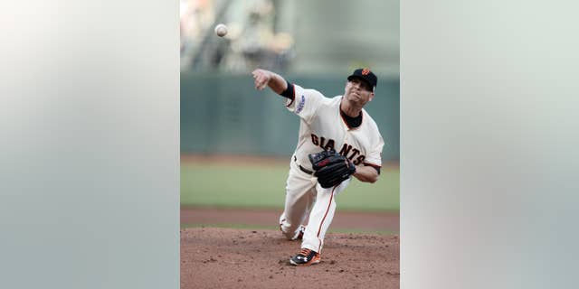 San Francisco Giants pitcher Tim Hudson throws during the first inning of Game 3 of baseball's World Series against the Kansas City Royals Friday, Oct. 24, 2014, in San Francisco. (AP Photo/Paul Buck, Pool)