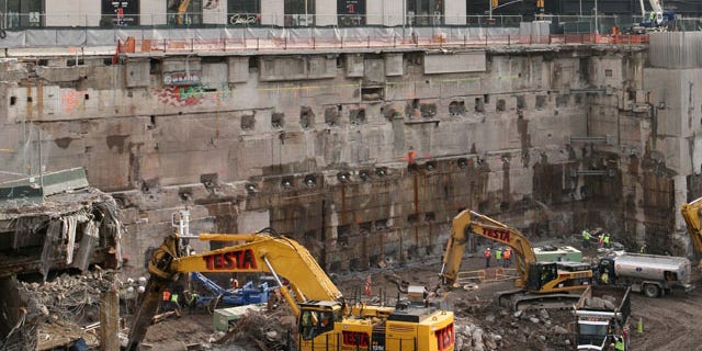 FILE: Construction workers and equipment excavate the southeastern corner of the World Trade Center site.
