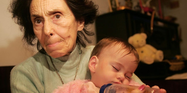 Adriana Iliescu, 67, holds her one-year-old daughter Eliza-Maria in her apartment in Bucharest, Romania January 16, 2006. Doctors said that one year ago, the 66-year-old Romanian woman was the world's oldest recorded woman to give birth. Iliescu, an university professor and author of children's books, gave birth after doctors used in vitro fertilization and the sperm and eggs from younger people, an act slammed by the Romanian Orthodox Church as 'selfish' and which stirred debate in the local press.