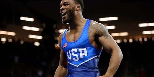FILE - In this April 10, 2016, Jordan Burroughs celebrates after beating Andrew Howe in their 75-kilogram freestyle finals match at the U.S. Olympic Wrestling team trials in Iowa City, Iowa. Burroughs burst onto the international scene in 2011, winning a world title just six months after leaving the University of Nebraska. (AP Photo/Charlie Neibergall, File)