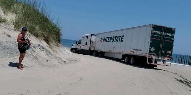 Currituck County Sheriff Matt Beickert said the driver was attempting to make a U-turn on the beach when the vehicle got stuck.
