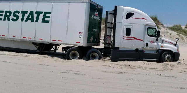 A truck driver followed his GPS the wrong way and ended up stranded on a North Carolina beach for hours.