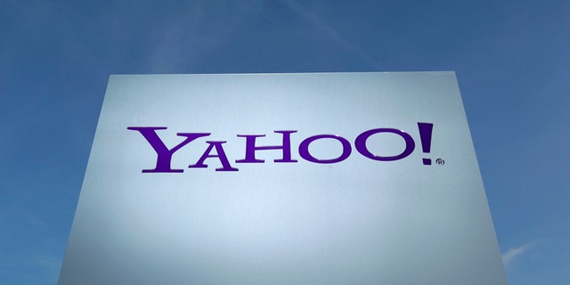 A Yahoo logo is pictured in front of a building in Rolle, 30 km (19 miles) east of Geneva, in this file picture taken December 12, 2012. Yahoo! Inc is shifting its main European tax base to Ireland from Switzerland, a Reuters examination of company statements and accounts shows, as pressure mounts on the Alpine nation to abolish some corporate tax incentives. Picture taken December 12, 2012. REUTERS/Denis Balibouse (SWITZERLAND - Tags: BUSINESS POLITICS LOGO) - RTX18CHS