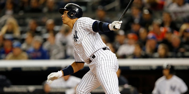 New York Yankees designated hitter Alex Rodriguez (13) hits a first-inning solo home run in a baseball game against the New York Mets at Yankee Stadium in New York, Sunday, April 26, 2015. Rodriguez now stands at 659 career home runs and needs one more to tie Willie Mays.  (AP Photo/Kathy Willens)