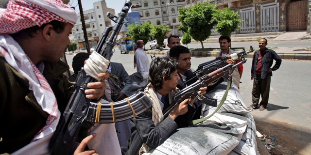 June 6: Armed tribesmen, loyal to Sheik Sadeq al-Ahmar, the head of the powerful Hashid tribe, stand guard in a street corner around al-Ahmar's house, during clashes with Yemeni security forces in Sanaa, Yemen.
