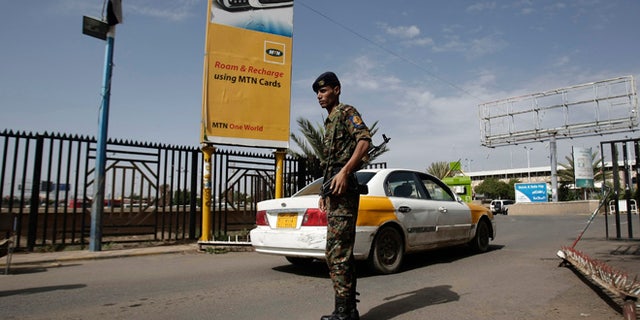Aug. 7, 2013: A policeman stands guard at the entrance of Sanaa International Airport, Yemen.