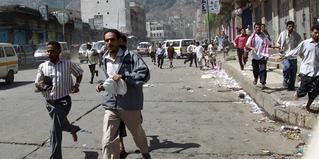 May 31: Government protesters run after soldiers opened fire to disperse them as they began gathering for a demonstration to demand the ouster of Yemen's President Ali Abdullah Saleh in the southern city of Taiz.