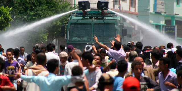 Sept. 20: Yemeni riot police use water cannons to disperse anti-government protestors during clashes, in Taiz, Yemen.