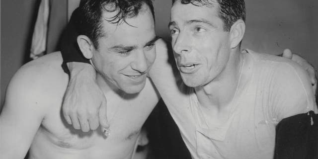Yogi Berra and Joe DiMaggio of the New York Yankees celebrate winning the 1950 World Series against the Philadelphia Phillies. (Photo by Sporting News/Sporting News via Getty Images)