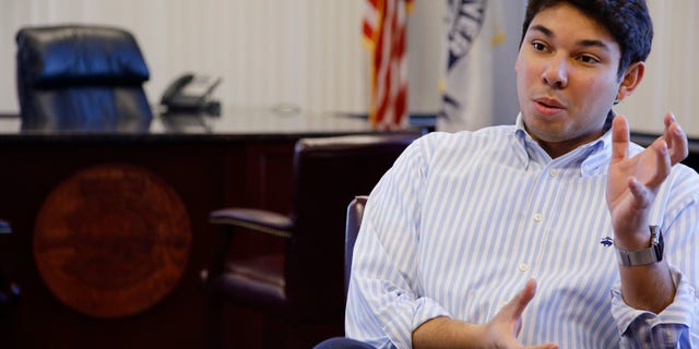 In this Wednesday, Jan. 6, 2016 photo newly elected Fall River Mayor Jasiel Correia has a conversation in his city hall office in Fall River, Mass. Correia, 24, is the youngest Fall River mayor to ever serve. (AP Photo/Stephan Savoia)