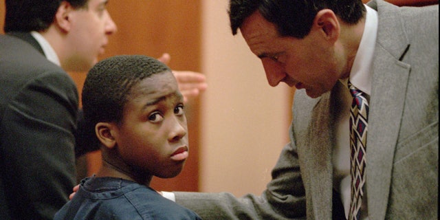 Feb. 11, 1998: Nathaniel Jamal Abraham, 12, of Pontiac, Mich., listens to his attorney in Juvenile court. Abraham, who committed murder at age 11, has been sentenced to five years of probation in a prison guard assault case.